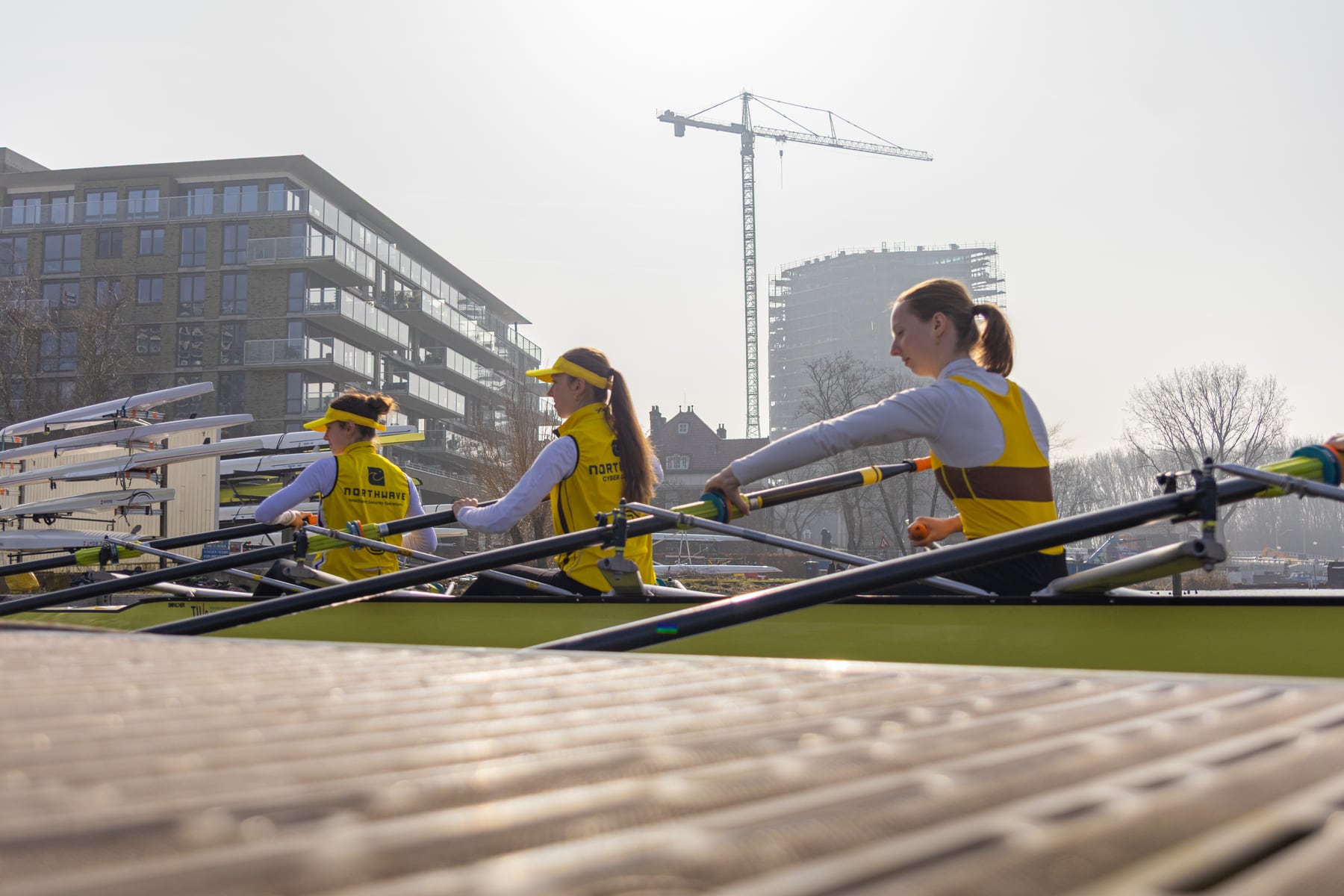 A low-angle view of rowers launching into Head of the River beside the dock.