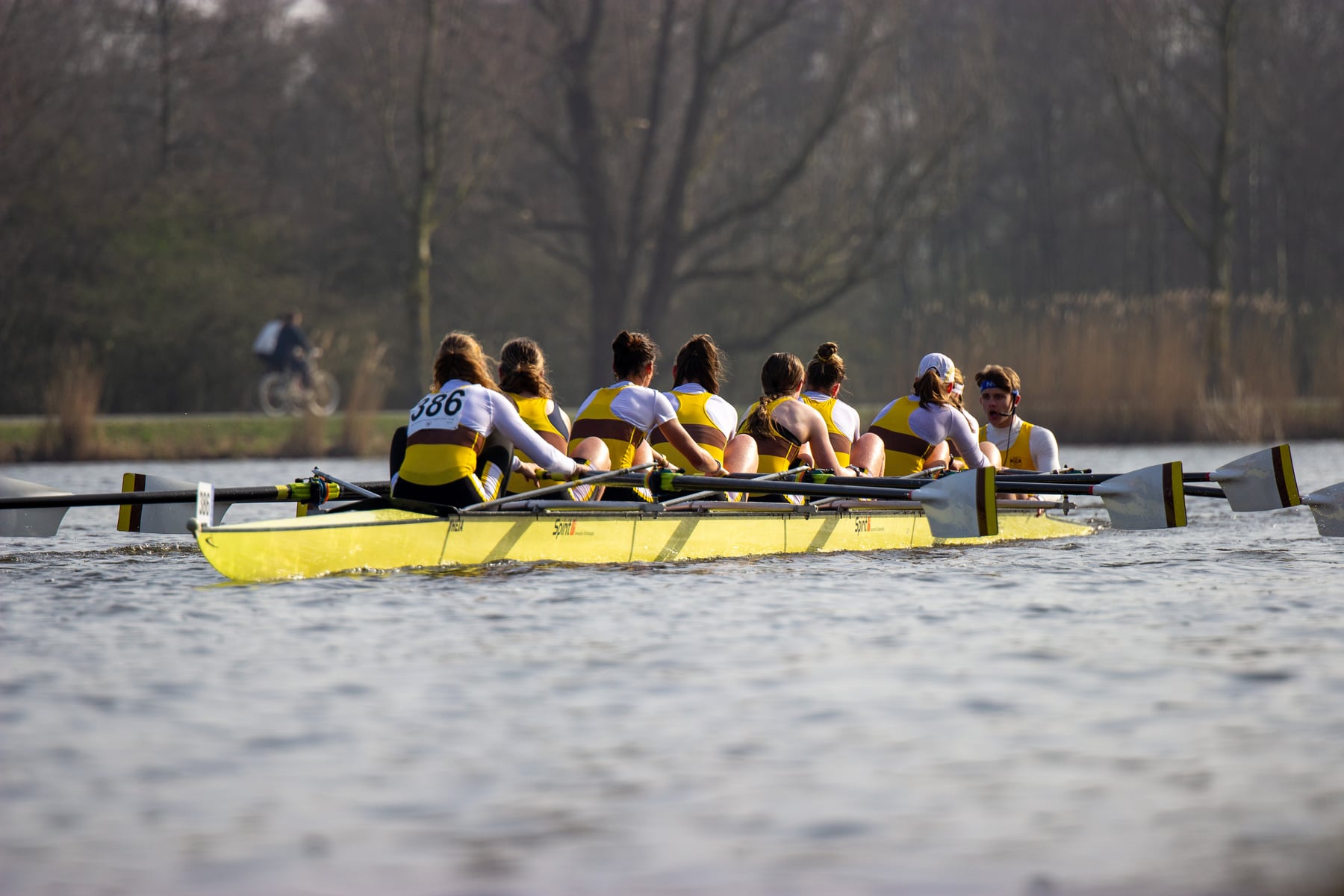 A yellow shell and chasing crew captured side by side on the course.